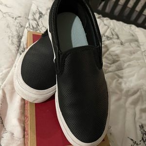 Black leather slip on vans.